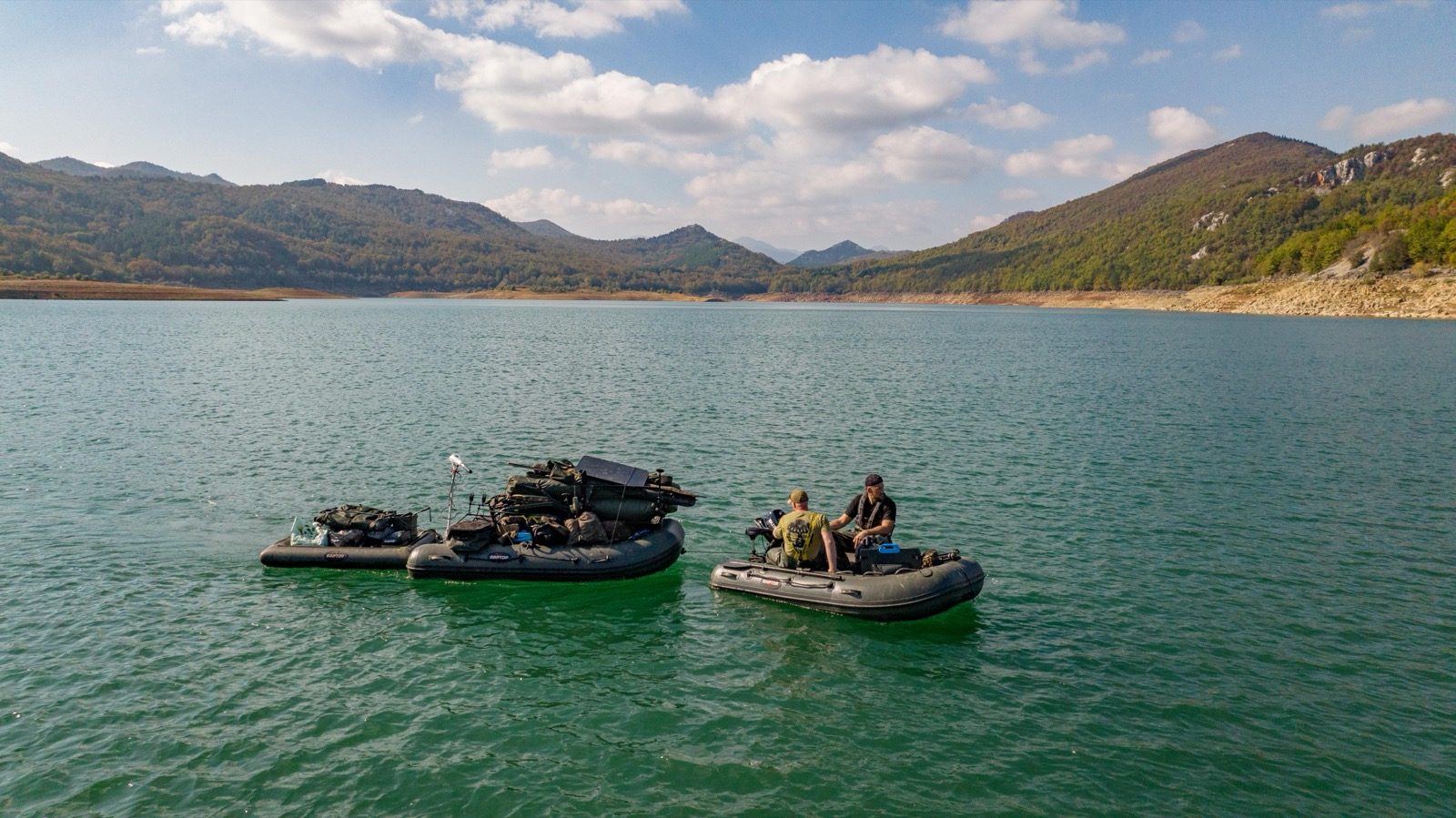 Two boats loaded with gear on a mountain reservoir