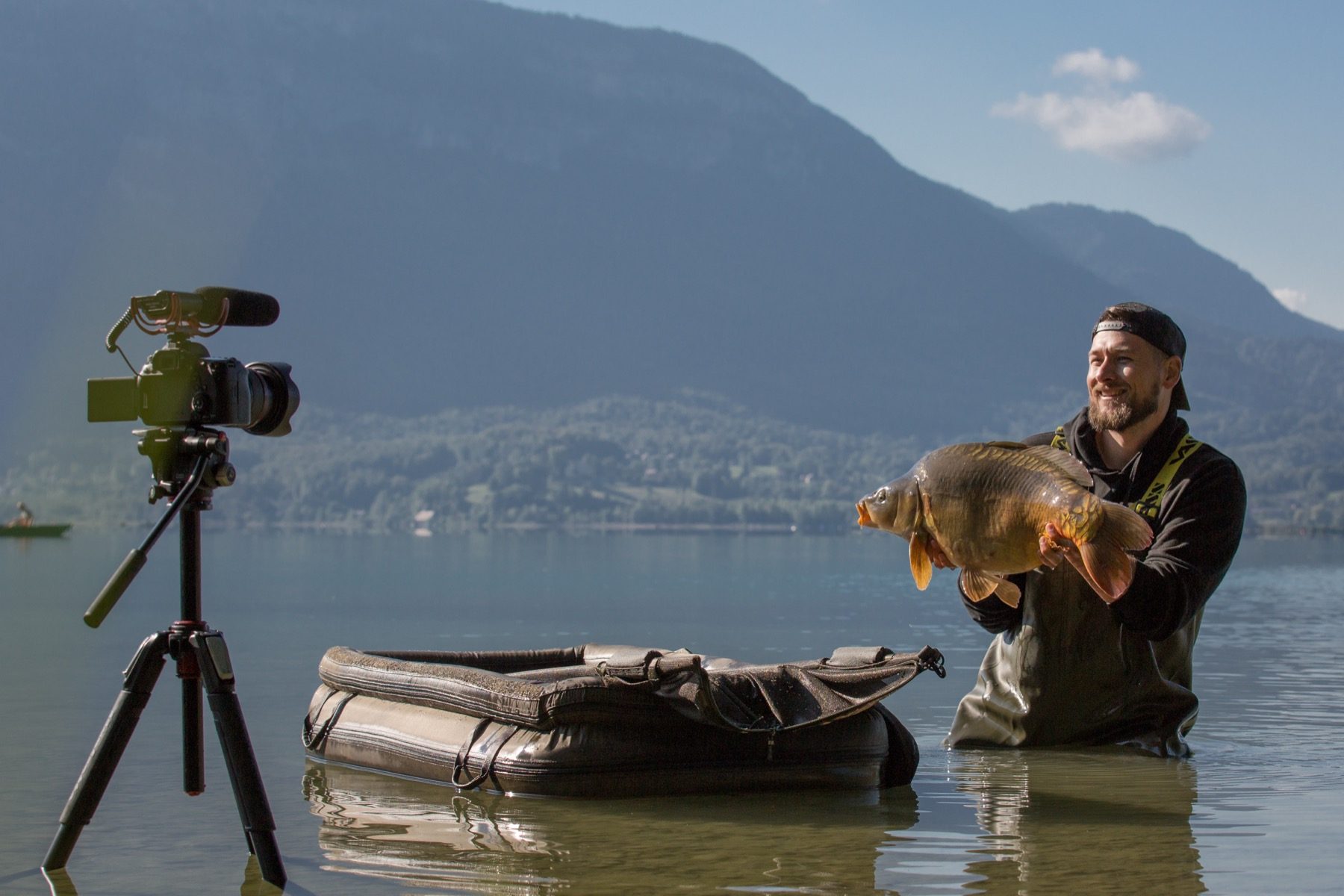 Jamie Bellhouse filming a mirror carp on location in the French Alps